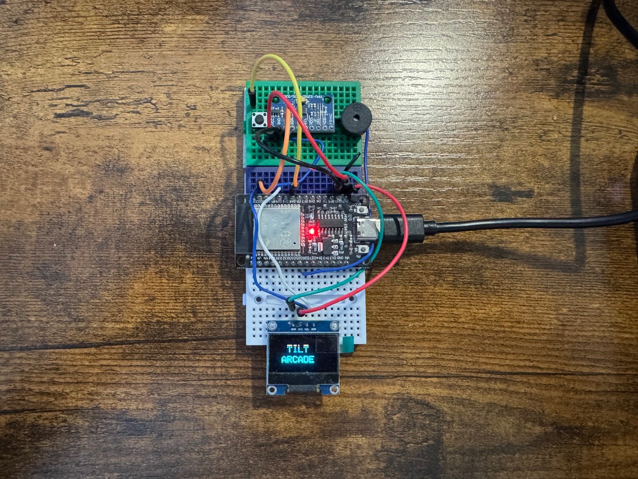 ESP32 Tilt Arcade Console breadboard build with OLED display, motion sensor, button, and buzzer